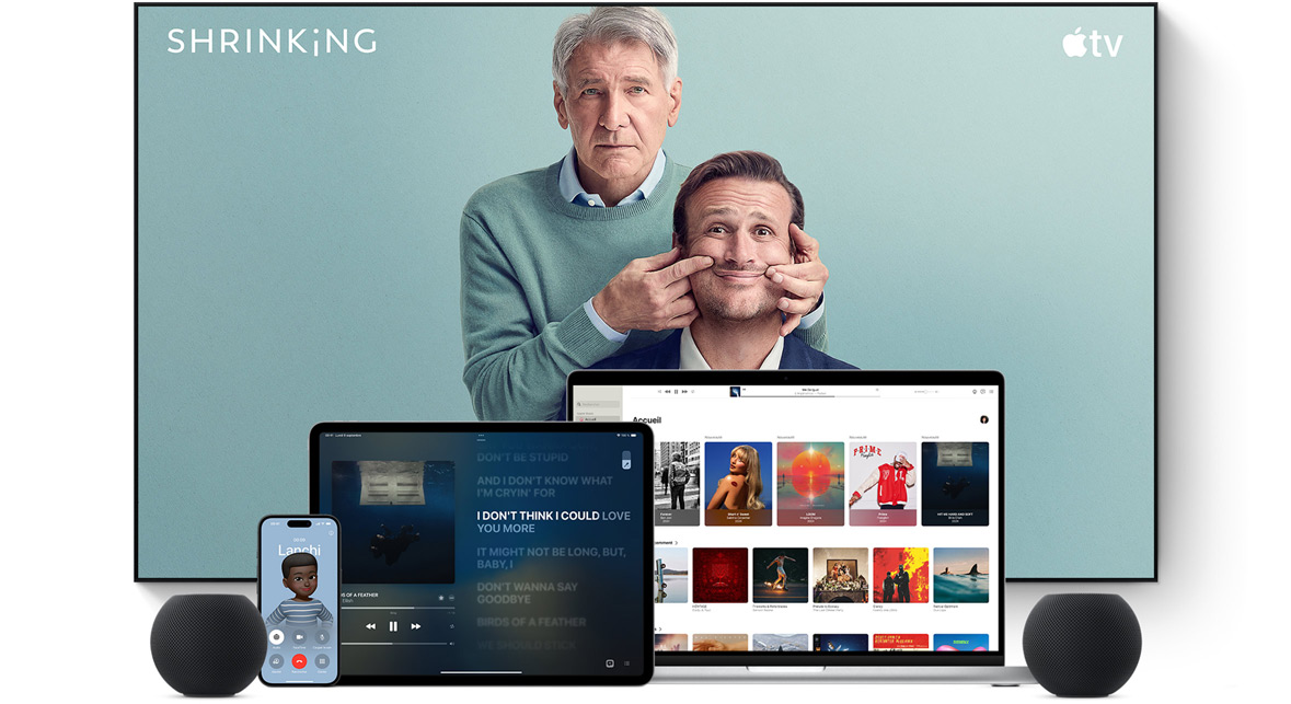 Large flat screen television showing two male characters from the Apple TV series shrinking. A MacBook Pro, an iPad, an iPhone, and a Midnight HomePod mini are arranged in front.