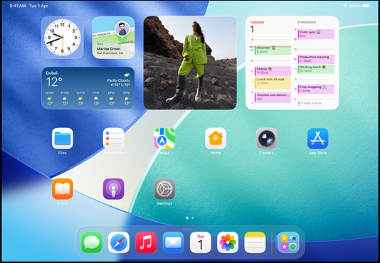 iPad, three models, landscape orientation, with center model in front of two others, Apple Pencil magnetically attached to top of center model, center screen showing the Home Screen featuring colorful app icons with Liquid Glass effect, left screen showing the Preview app, right screen showing Home Screen with files fanning out from the dock