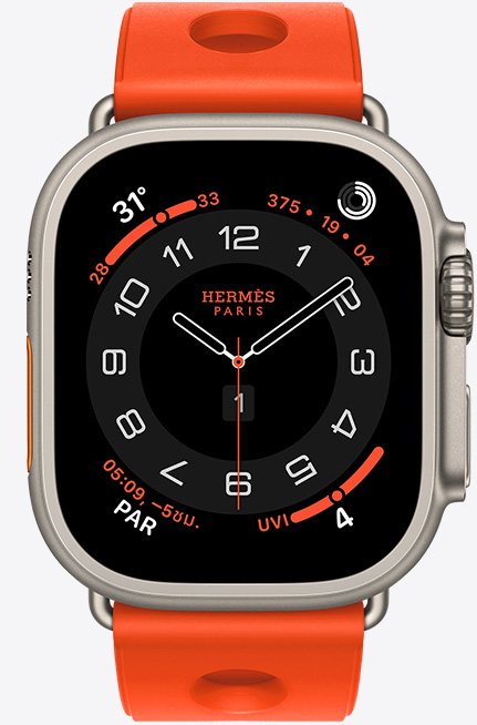 Apple Watch Hermès Ultra 3, Circulaire analog watch face, (hour, minute and second hands, complications: Weather, activity rings, Paris time and UV Index), titanium case, natural color, right side exterior, Digital Crown, raised side button, paired with Scub'H Diving band, orange néon color (bright orange), molded rubber material, circular cutouts centered