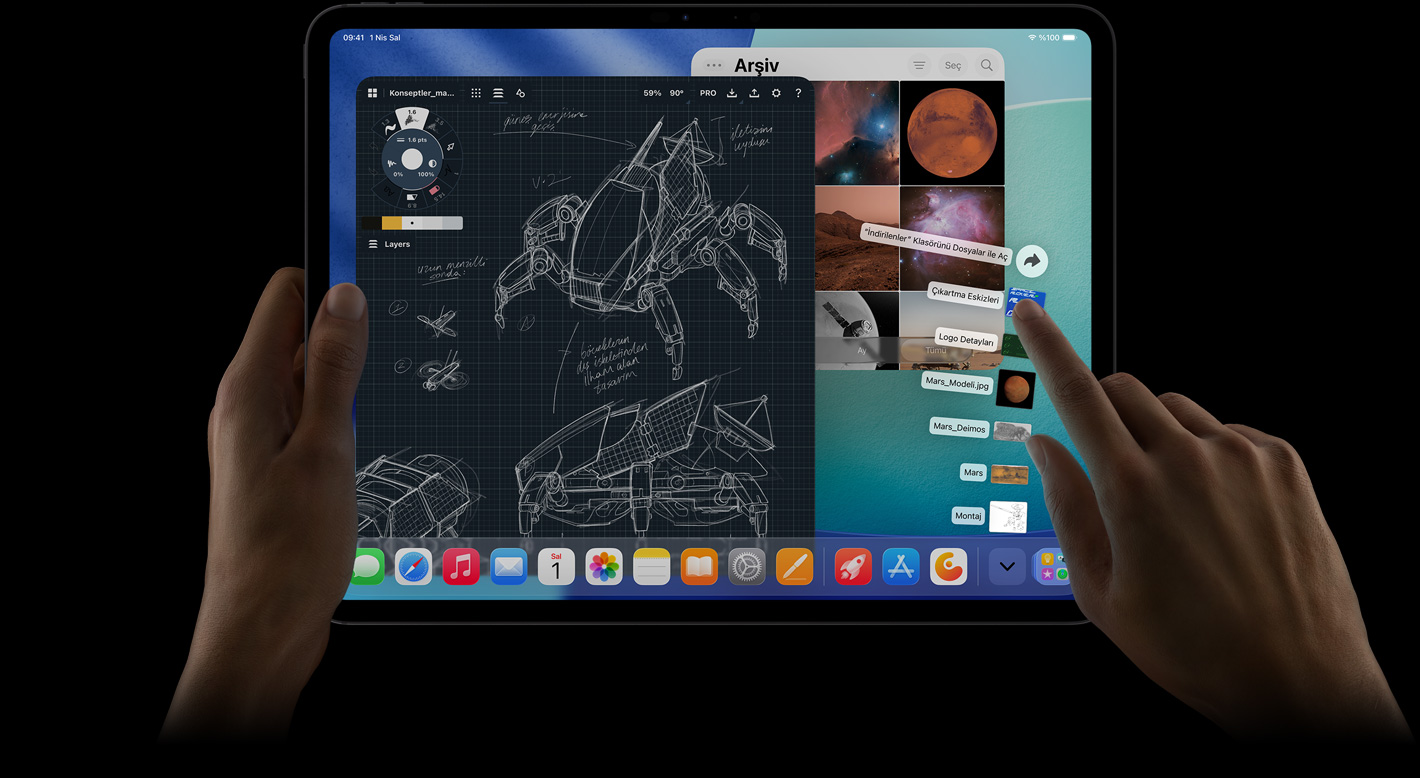 iPad Pro, önden dış görünüm, yatay pozisyonda, sol el aygıtı tutuyor, sağ el yelpaze şeklinde açılmış İndirilenler klasörü dosyalarına işaret ediyor, ekranda ayrıntılı robot projelerinin, el yazısı notların ve çok sayıda tasarım aşamasının yer aldığı bir fotoğraf düzenleme uygulaması dahil birden fazla uygulamanın ve Fotoğraflar Arşivi’nin açık olduğu iPadOS 26 arayüzü gösteriliyor