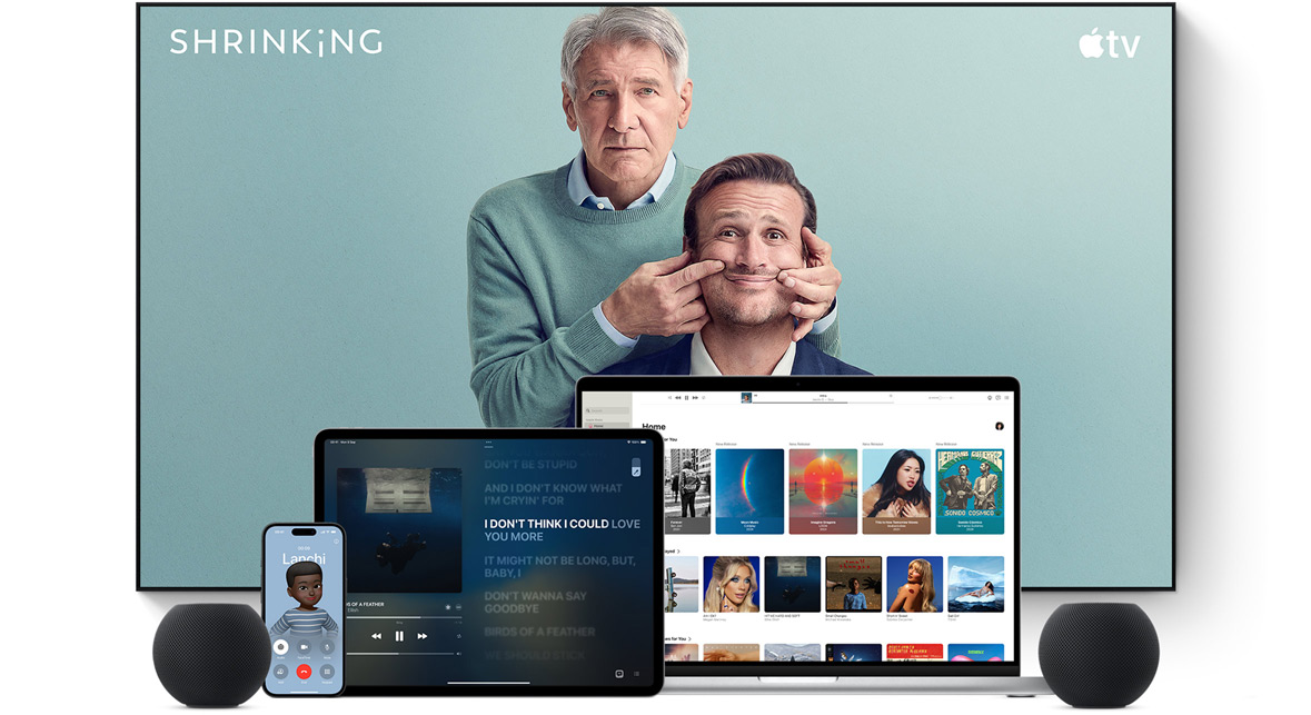 Large flat screen television showing two male characters from the Apple TV series shrinking. A MacBook Pro, an iPad, an iPhone, and a Midnight HomePod mini are arranged in front.