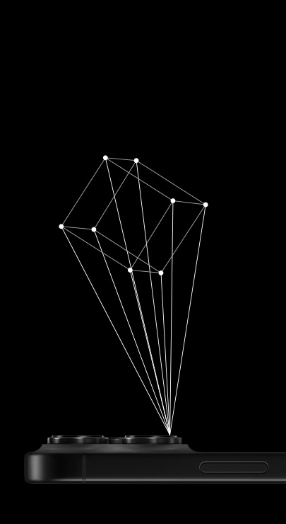 Un iPhone est posé face vers le bas et son scanner LiDAR projette les contours d’un cube en 3D