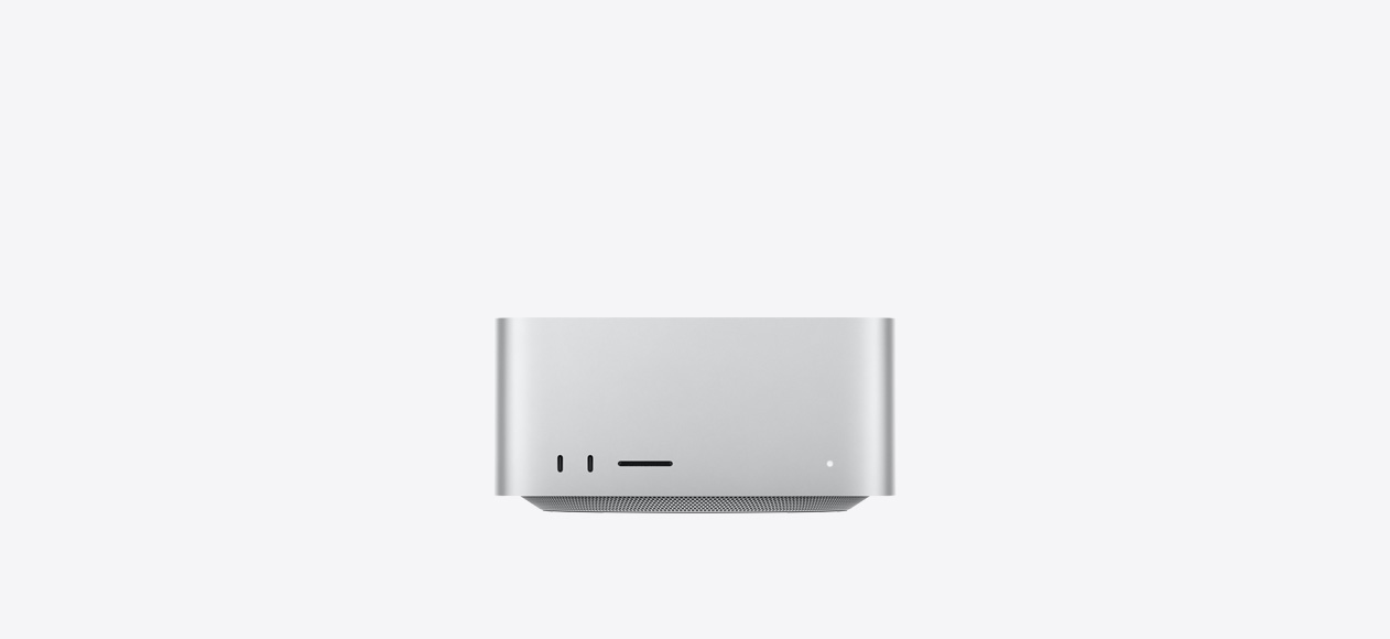 Mac Studio, front, two USB-C ports, SDXC card slot, status indicator light, tapered base at bottom, flat top, rounded sides, straight edges, silver color