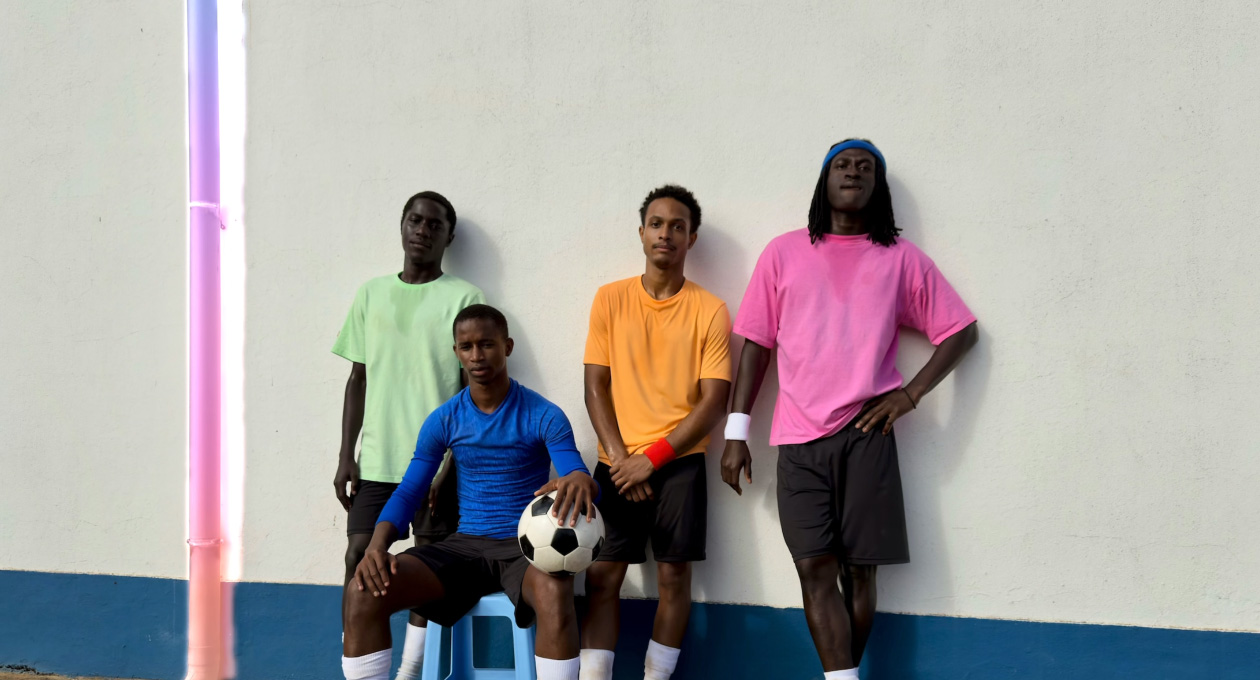 Using Clean Up tool to remove a drainpipe from a photo of soccer players posed against a wall