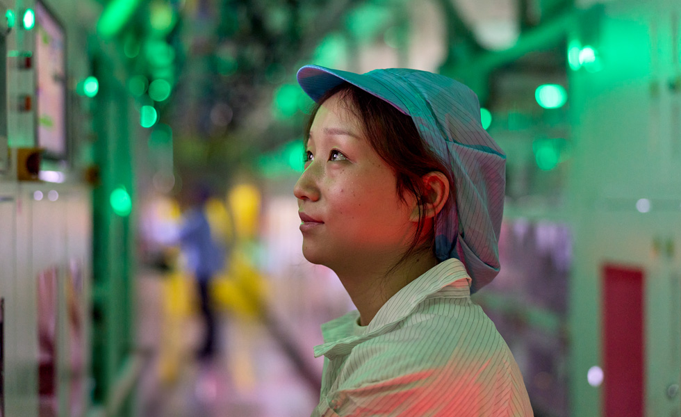 A uniformed employee in a component manufacturing facility